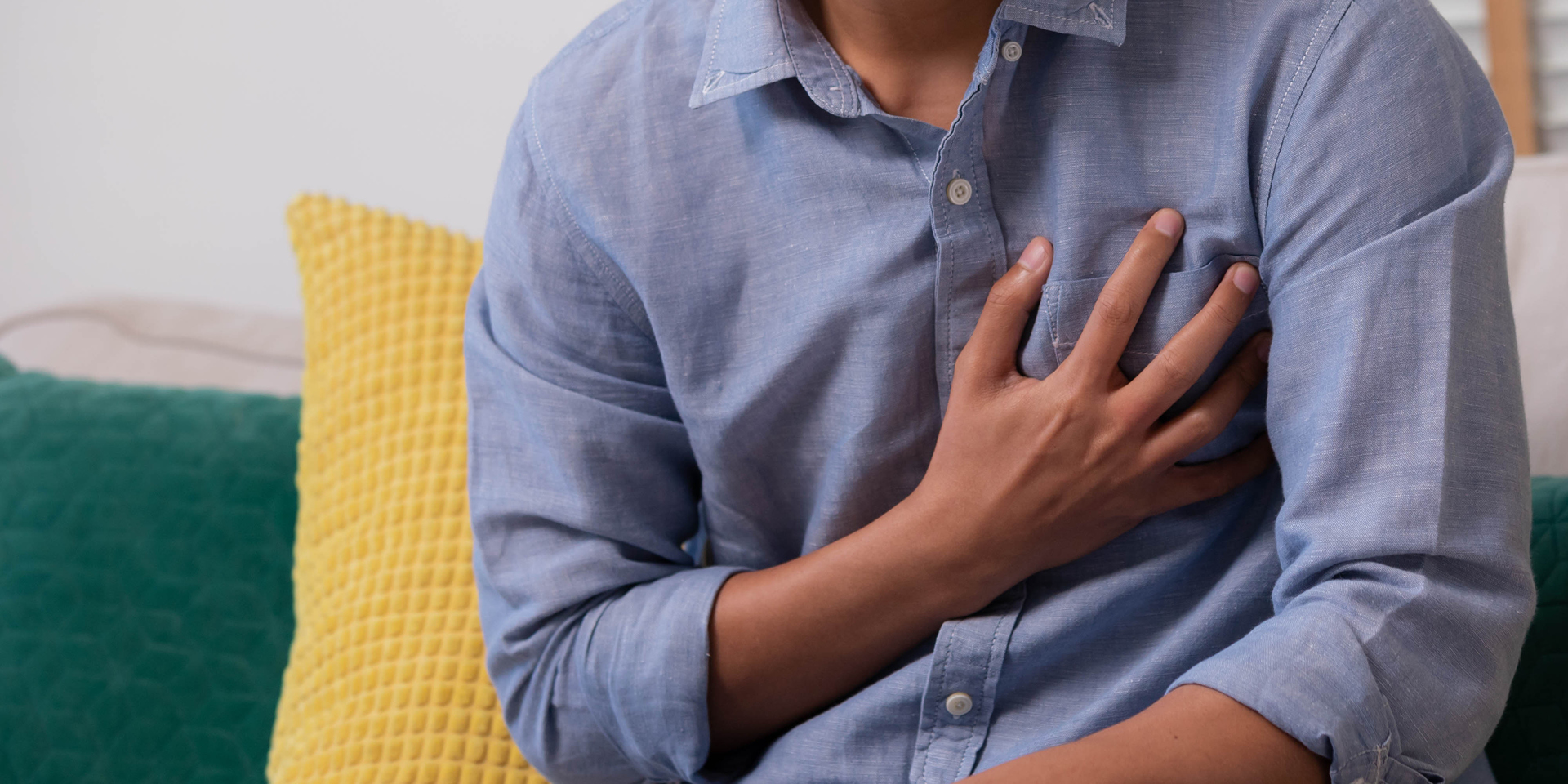 man clutching chest