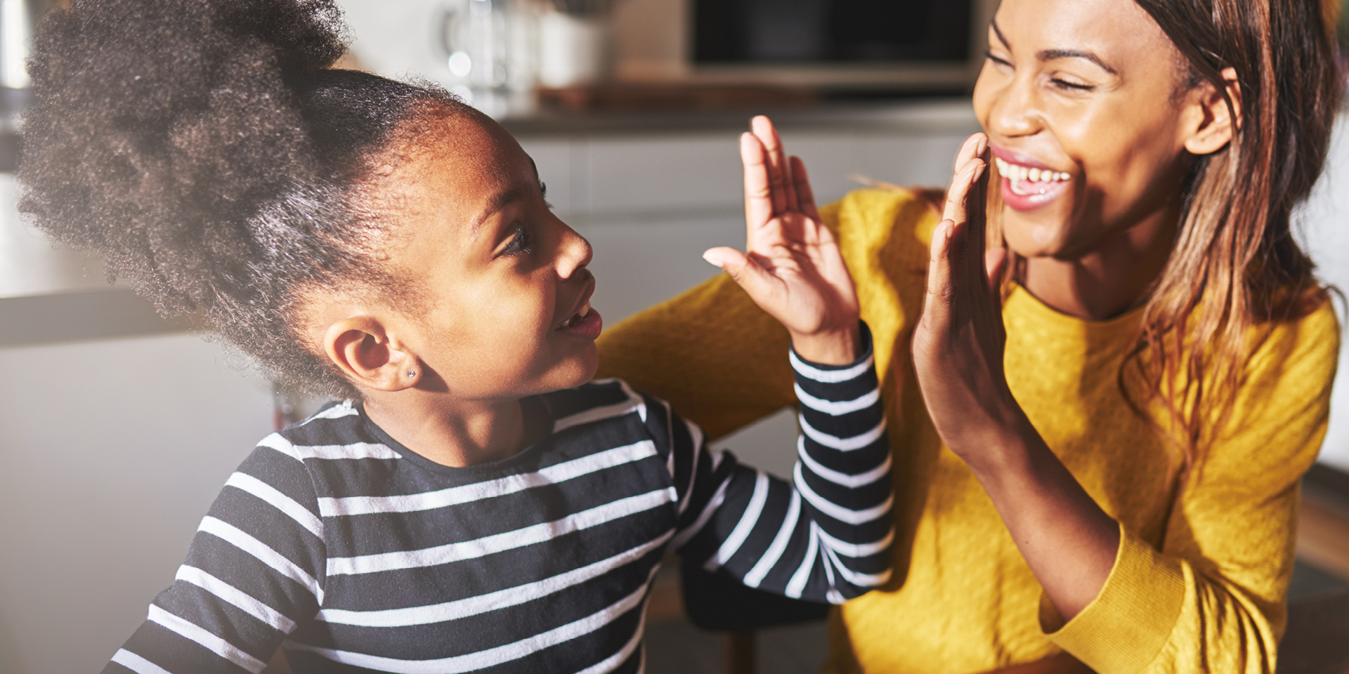little girl and mom high-fiving