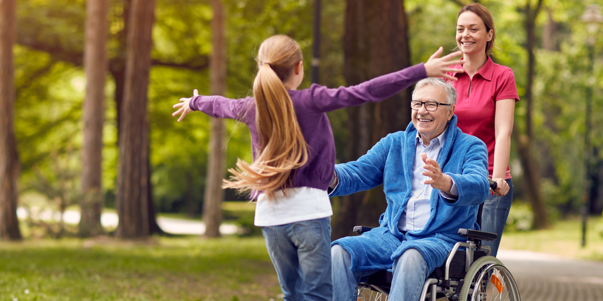 Granddaughter with outstretched arms for grandfather in wheelchair