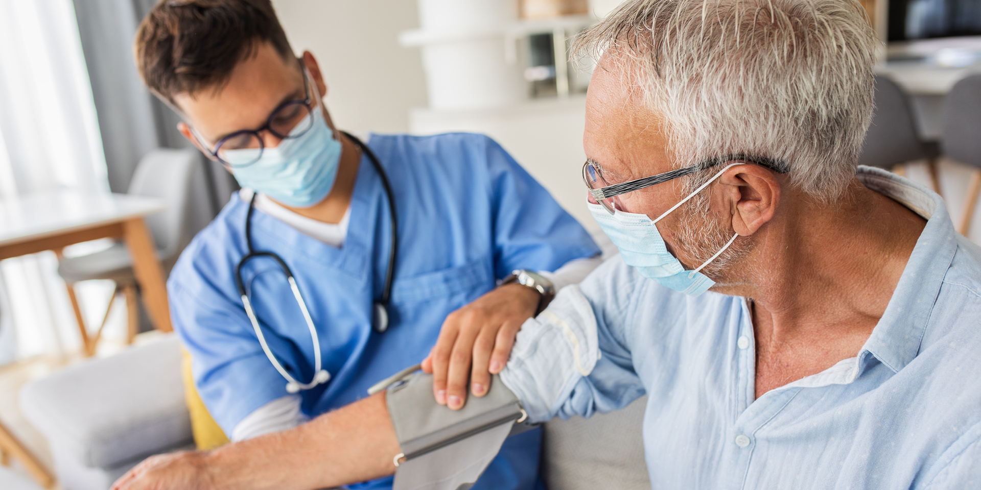 Provider is taking blood pressure measurements for a patient | Doylestown Health