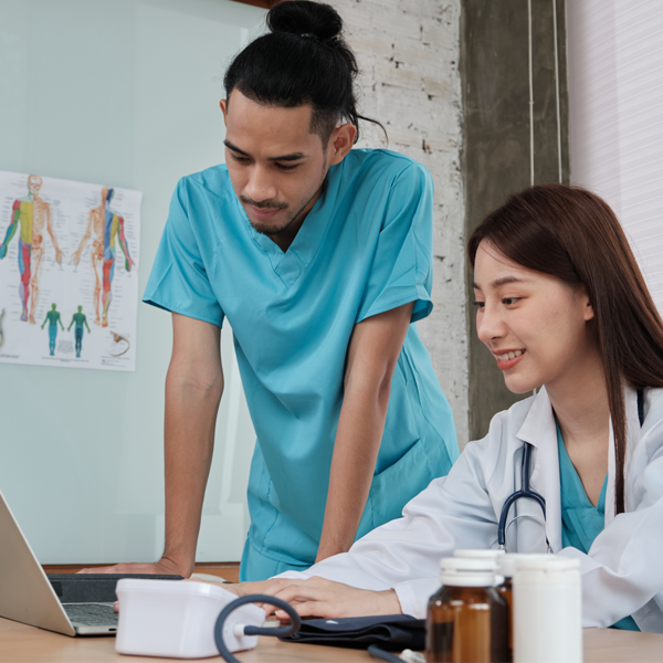 Two uniformed young doctors work in medical clinic office | Doylestown Health